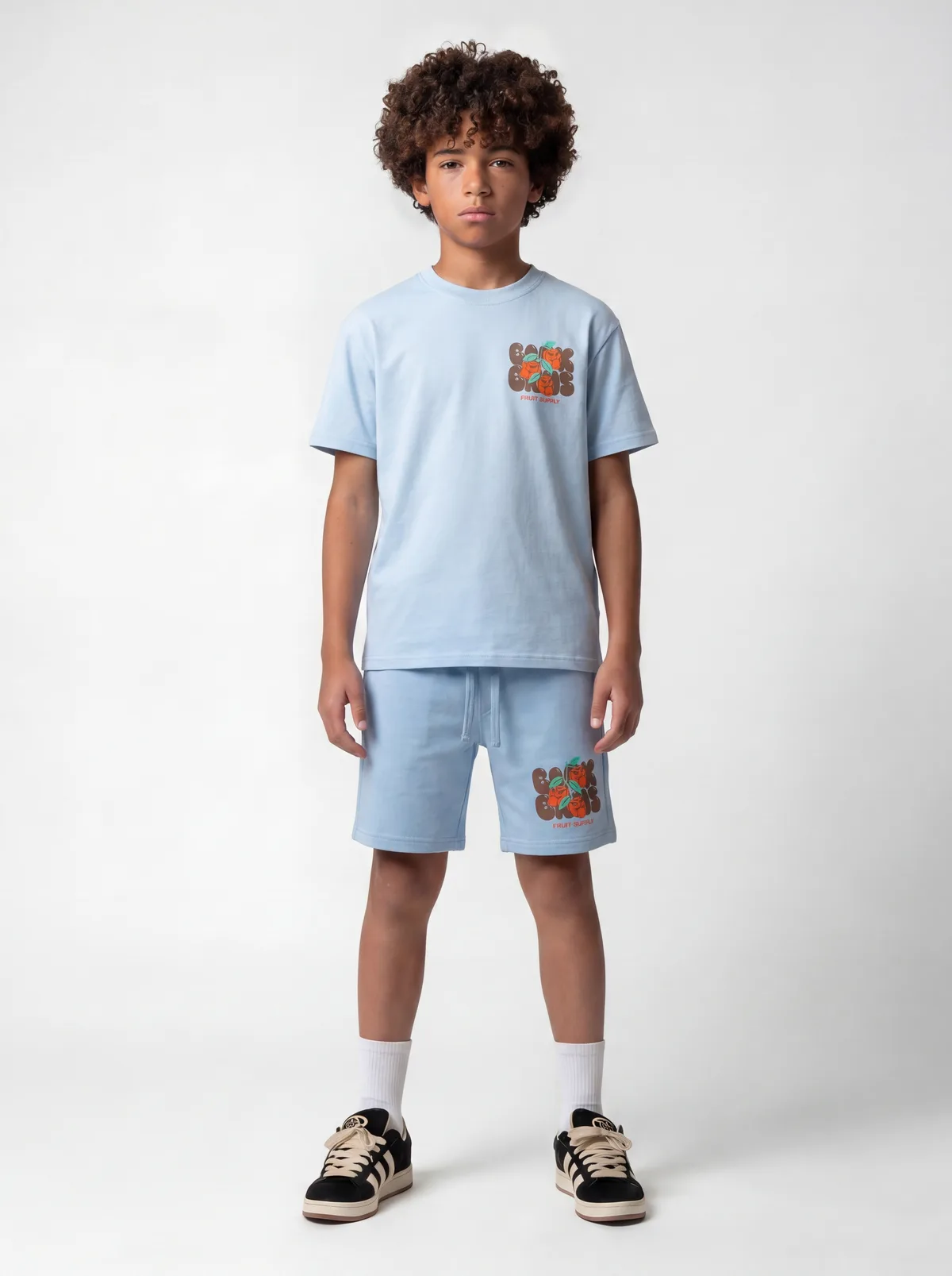 Black Bananas light blue Fruit Supply chest-print tee and matching short twinset on AI young model in clean white studio