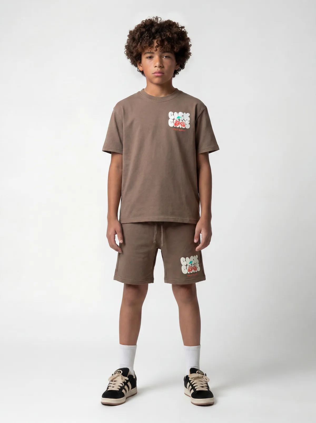 Black Bananas warm brown Fruit Supply chest-print tee and shorts twinset on AI young model in clean white studio