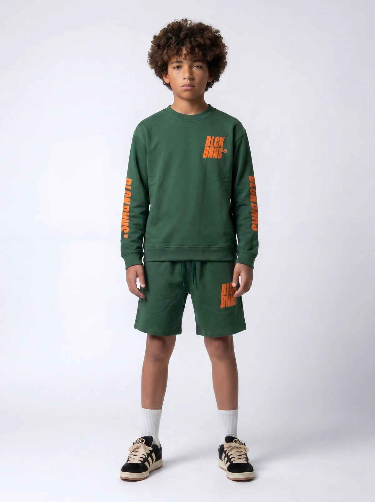 Black Bananas forest green BLCK BNNS orange-print long-sleeve and shorts twinset on AI young model in clean white studio