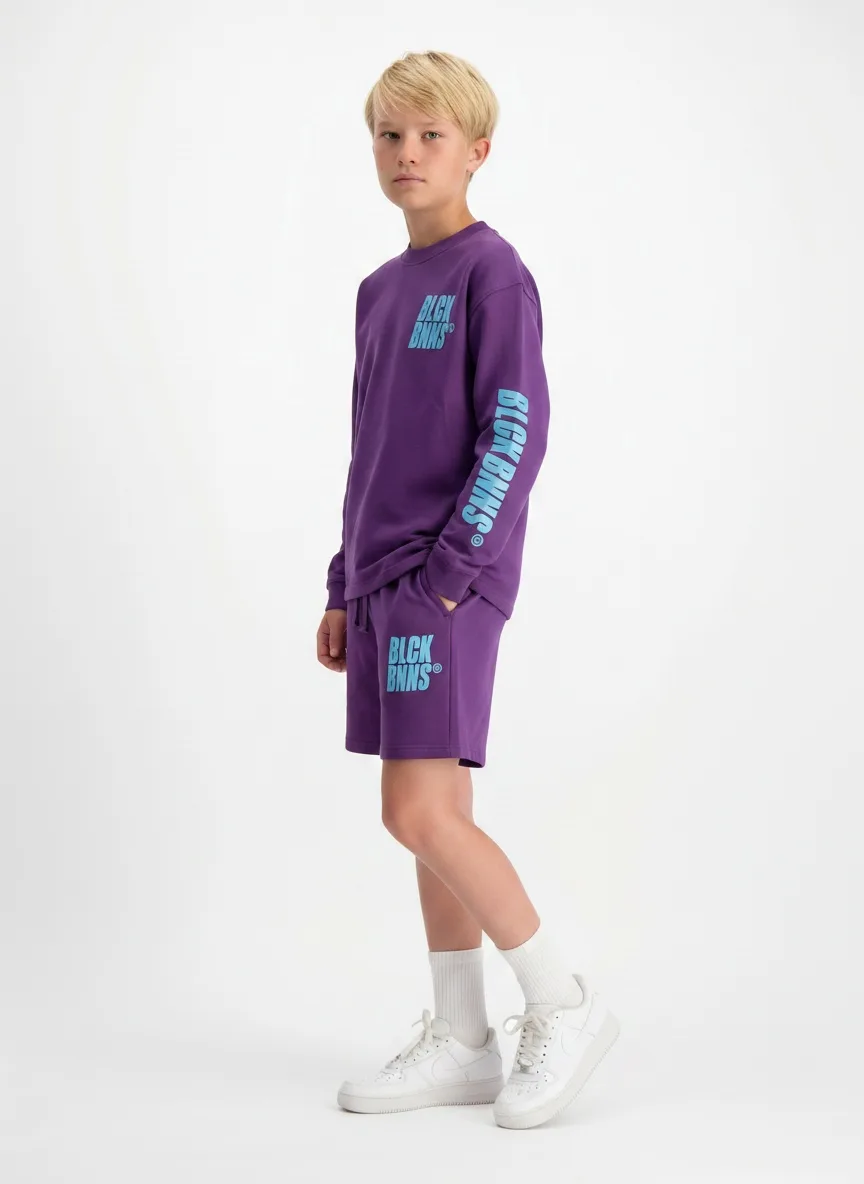 Black Bananas purple BLCK BNNS twinset three-quarter walking pose on AI young model in studio