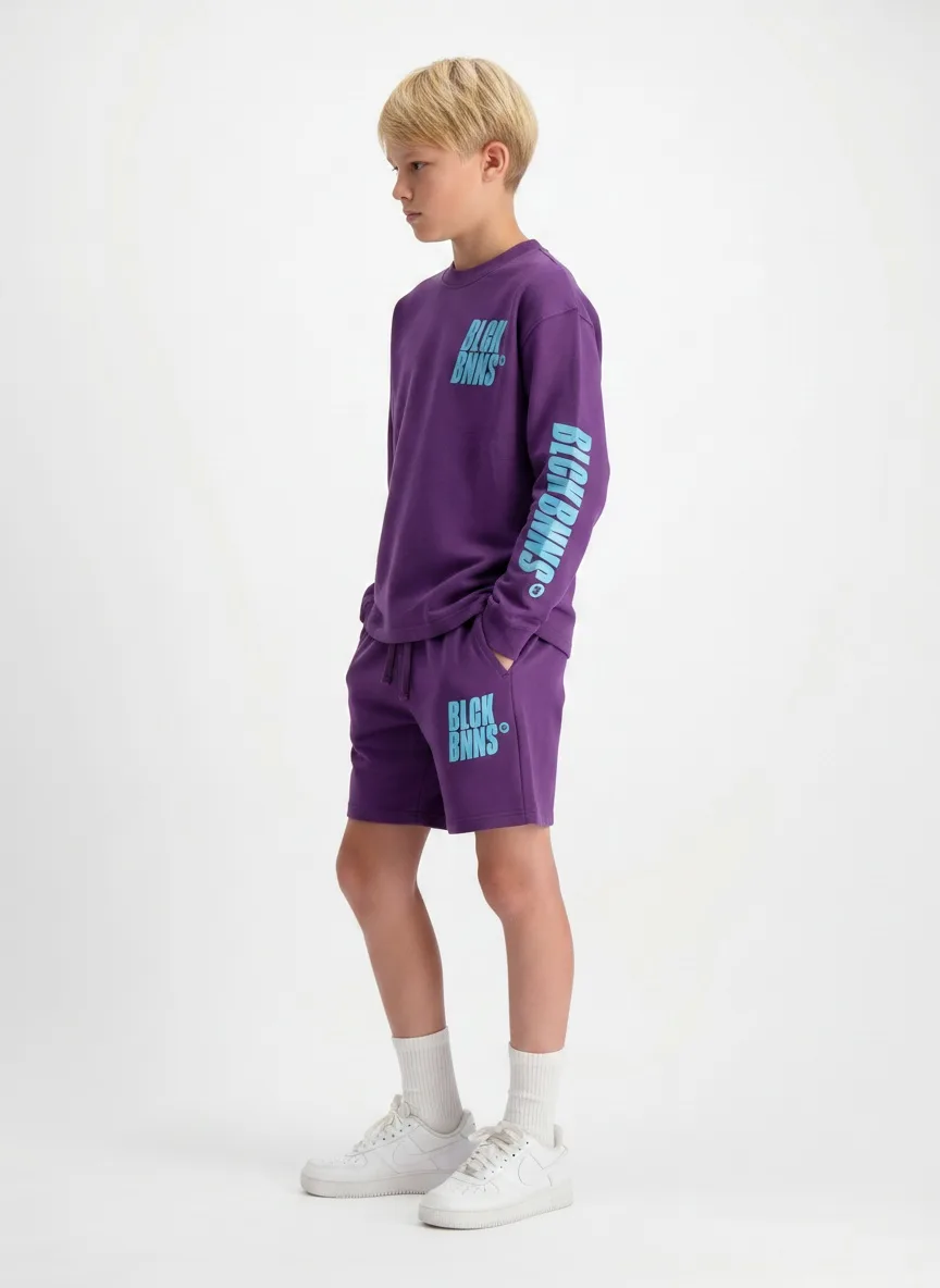Black Bananas purple long-sleeve and short twinset side profile on AI young model in clean studio