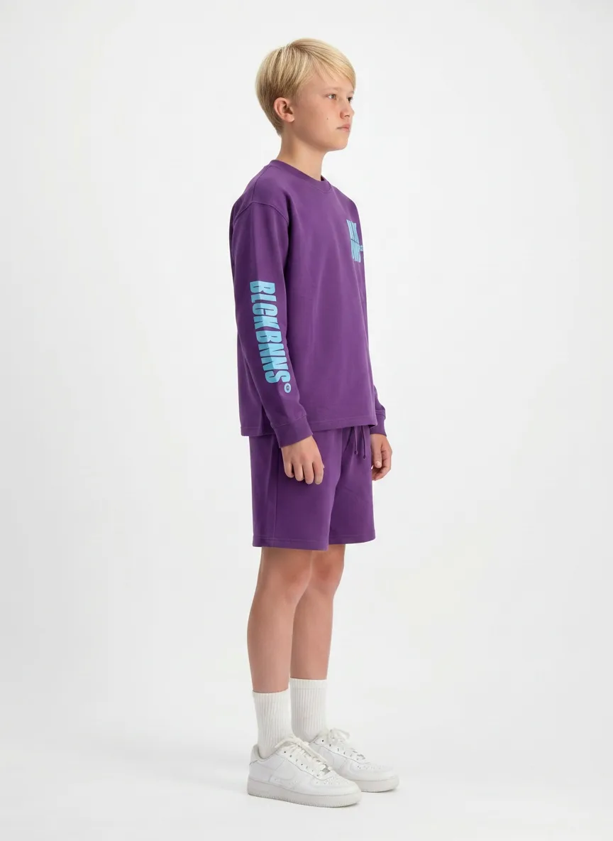 Black Bananas purple twinset seated relaxed pose on AI young model in clean studio