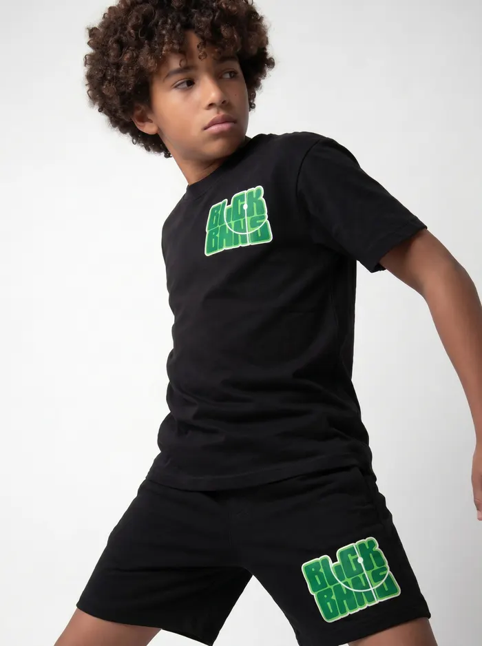 Black Bananas black BLCK BNNS green-print tee chest detail crop on AI young model in clean studio