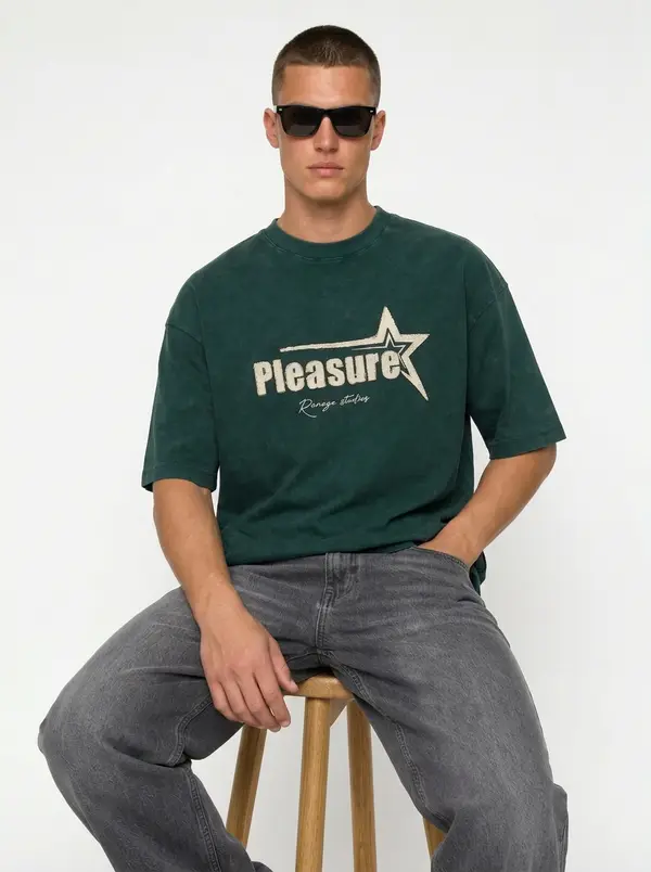 Bully Pleasure forest green oversized tee, seated editorial pose