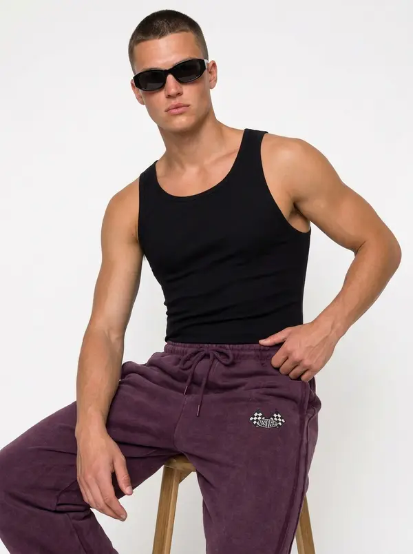 Bully plum checkered-flag sweatpant, seated editorial pose