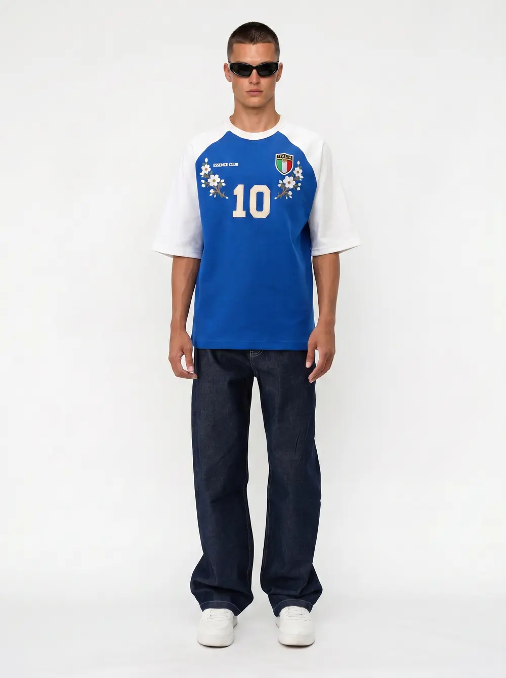 Bully Essence Club royal blue and white raglan football tee with dark denim on an AI male model in black sunglasses, straight-on front, bright white studio