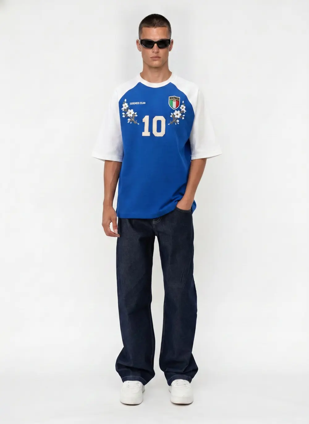 Bully Essence Club raglan tee, three-quarter stance with hands in pockets, on an AI male model in a bright white studio