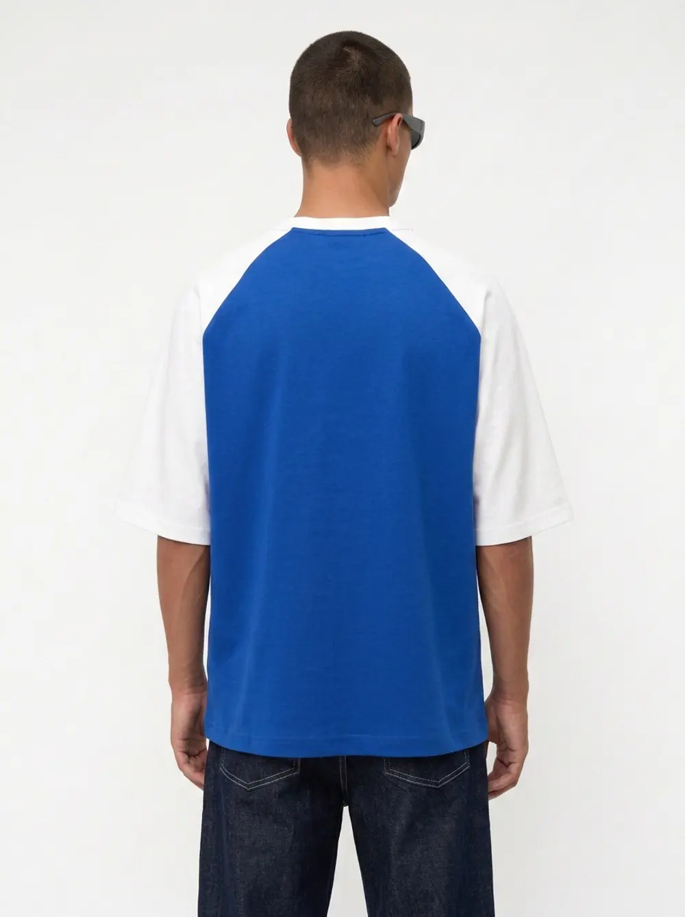 Bully Essence Club raglan tee back view showing the blue and white raglan sleeve blocking on an AI male model