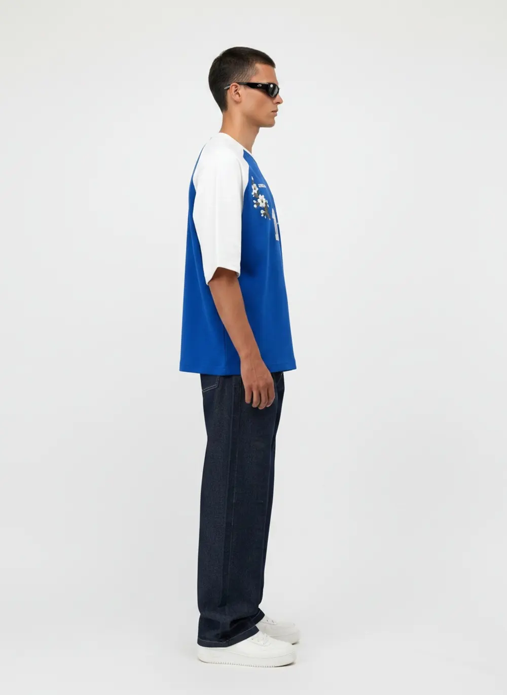 Bully Essence Club raglan tee, side profile full length, on an AI male model in a bright white studio