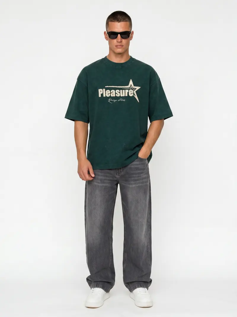 Bully Pleasure star-graphic oversized tee in forest green with grey denim, on an AI male model