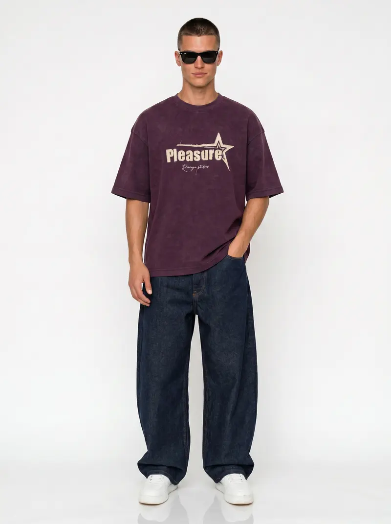 Bully Pleasure star-graphic oversized tee in washed plum with indigo baggy denim, on an AI male model