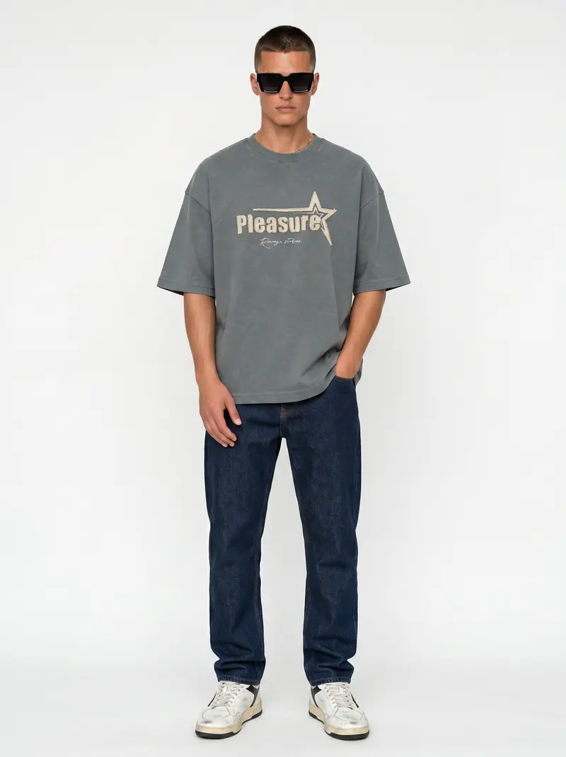 Bully Pleasure star-graphic oversized tee in washed sage with dark denim, on an AI male model