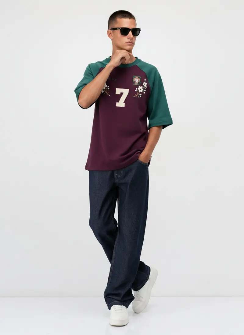 Bully Essence Club raglan tee in plum with green sleeves and an appliqué number 7, on an AI male model