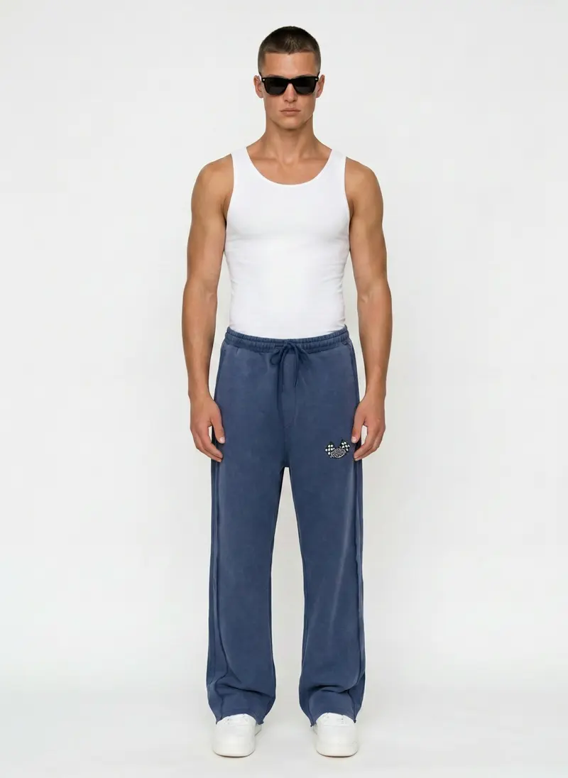 Bully checkered-flag sweatpant in washed denim blue with a white tank, on an AI male model