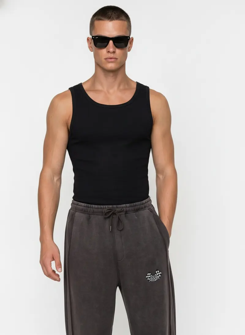 Bully checkered-flag sweatpant in charcoal wash with a black tank, on an AI male model
