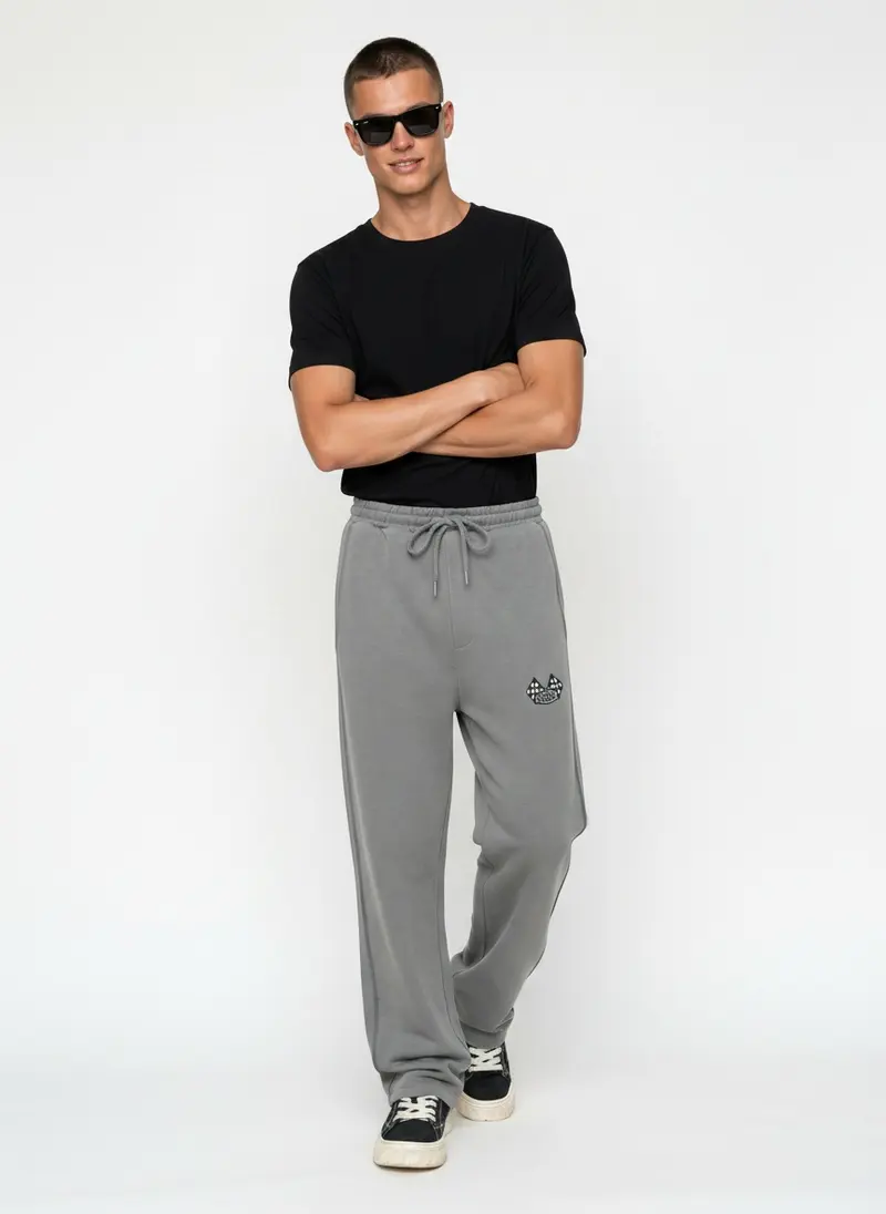 Bully checkered-flag sweatpant in silver grey with a black tee, on an AI male model
