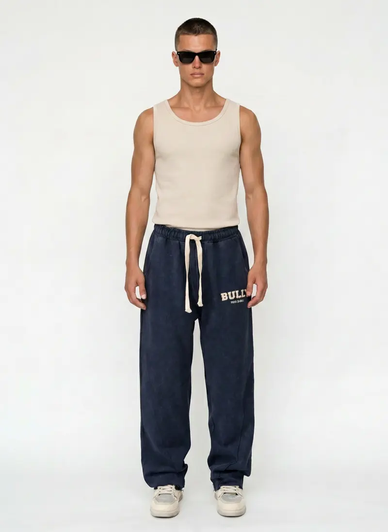 Bully wordmark sweatpant in navy acid wash with a ribbed tank, on an AI male model