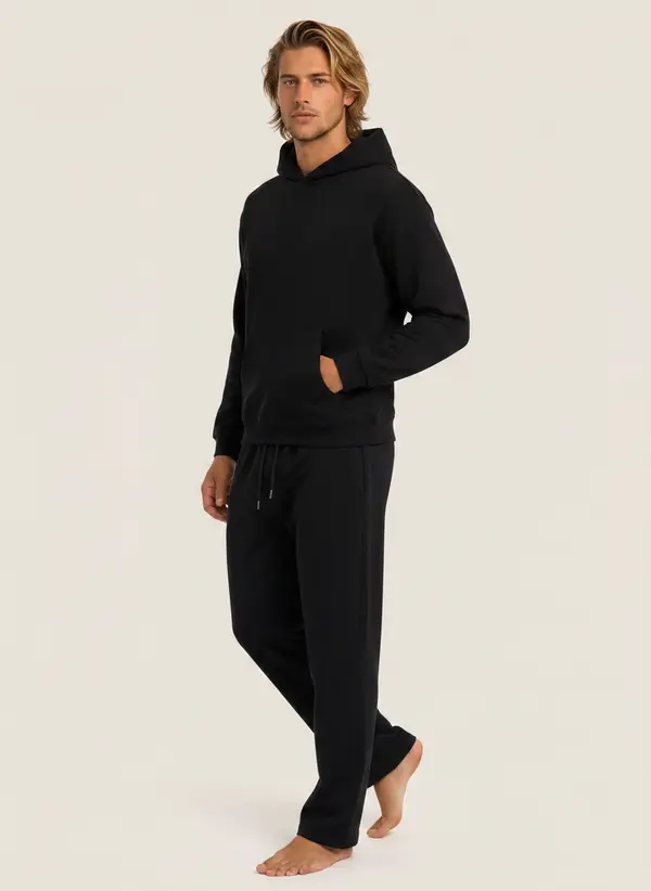 Future Homme black hooded set, three-quarter walking frame, on an AI male model