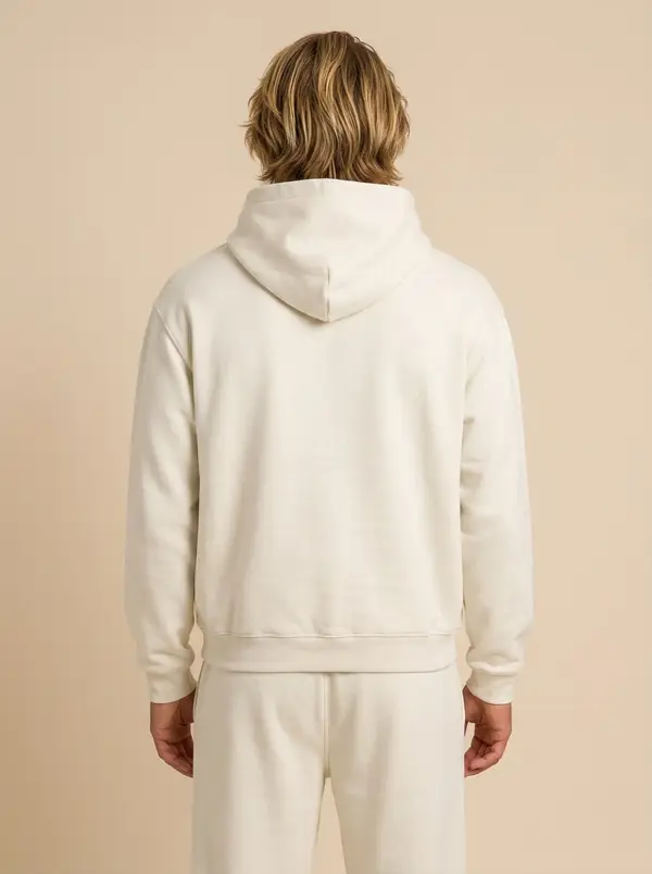 Future Homme bone hooded set, back view showing hood volume, on an AI male model against warm sand