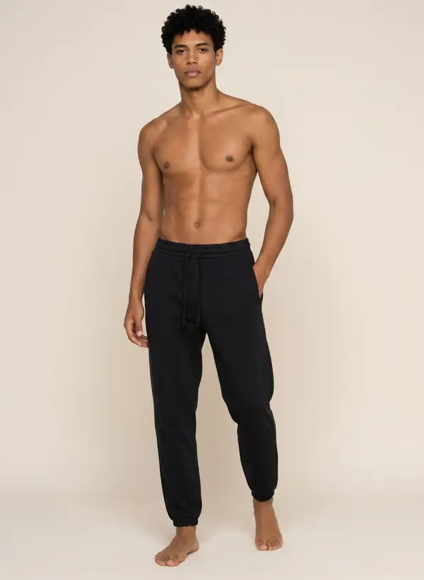 Future Homme navy jogger, three-quarter frame, bare chest, on the second AI muse