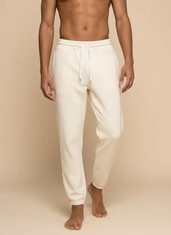 Future Homme cream jogger, waist-down detail crop showing drawcord and elastic, on the second AI muse