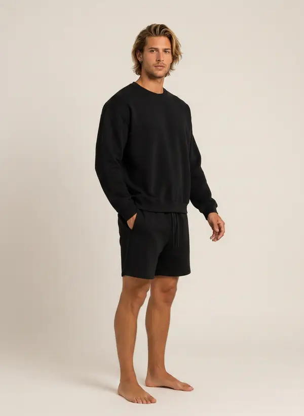 Future Homme black crew and short set, three-quarter turn, on an AI male model in a warm studio