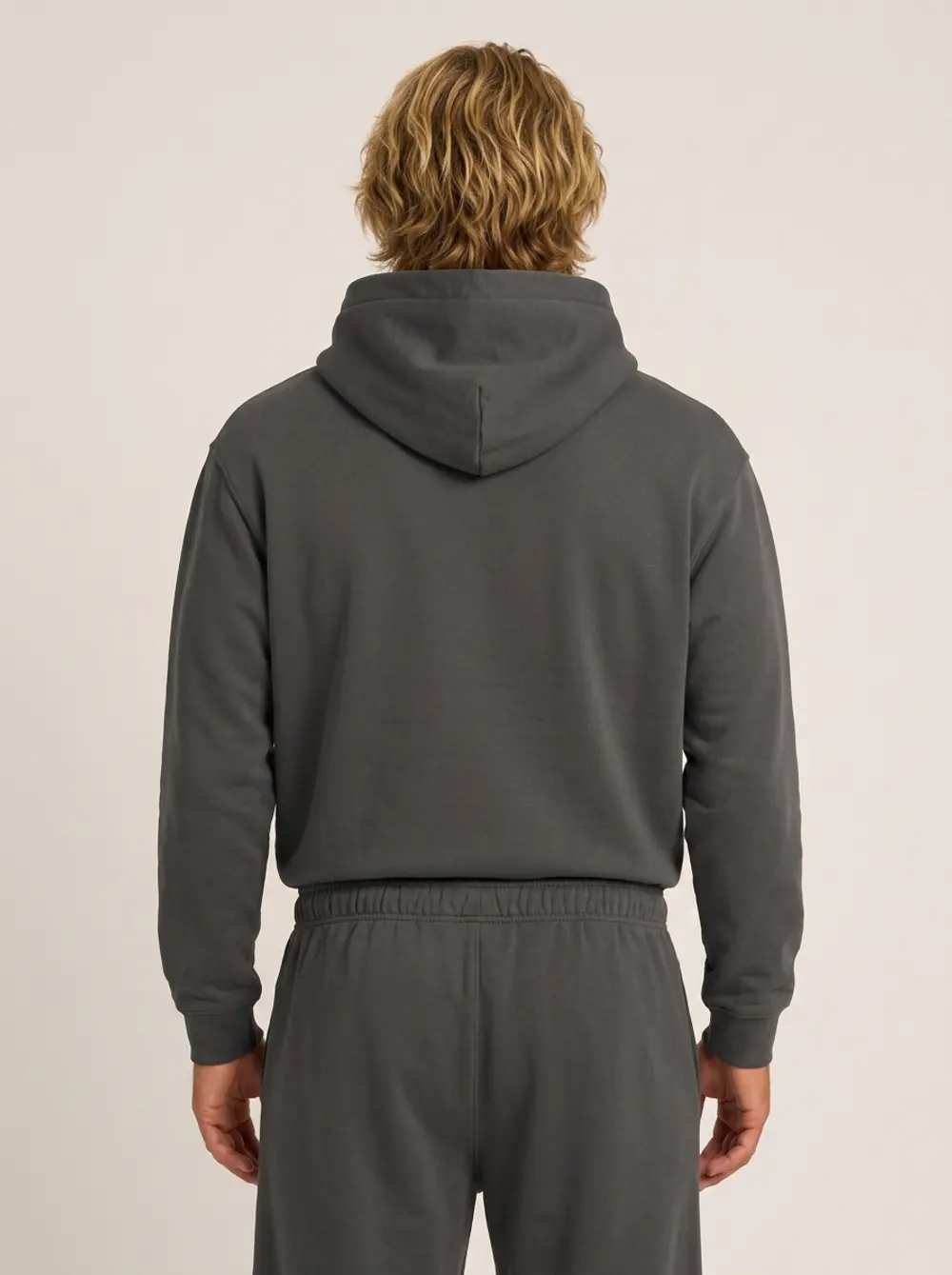 Future Homme graphite hoodie back view showing hood drape and shoulder seam on an AI male model