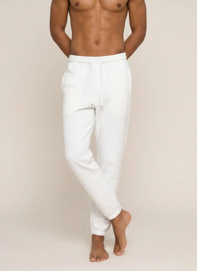 Future Homme ivory jogger on the second AI male muse, three-quarter walking frame
