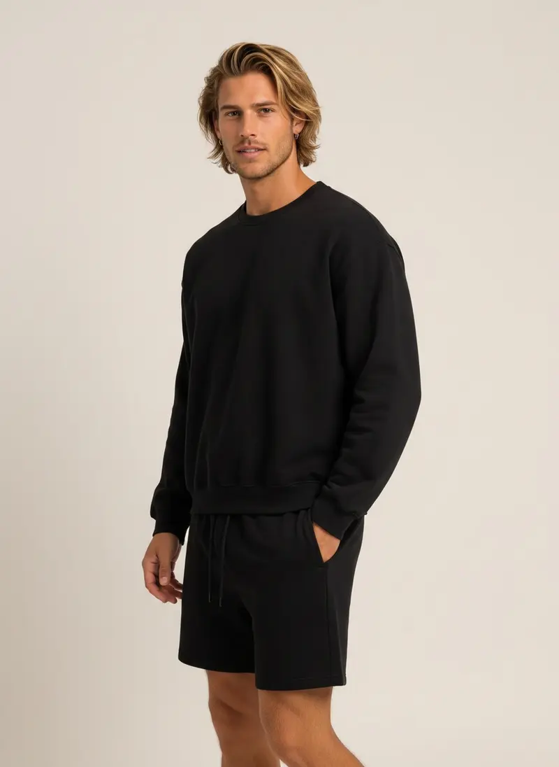 Future Homme black crew sweatshirt and matching short set on an AI male model, three-quarter frame in a warm studio