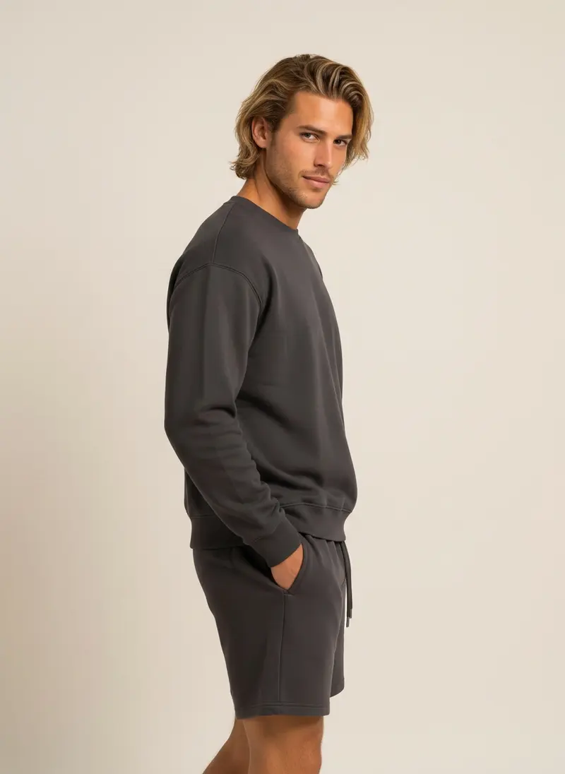 Future Homme graphite crew sweatshirt and matching short set on an AI male model, three-quarter frame