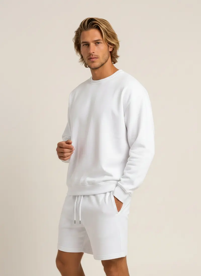 Future Homme white crew sweatshirt and matching lounge short set on an AI male model, three-quarter frame in a warm studio