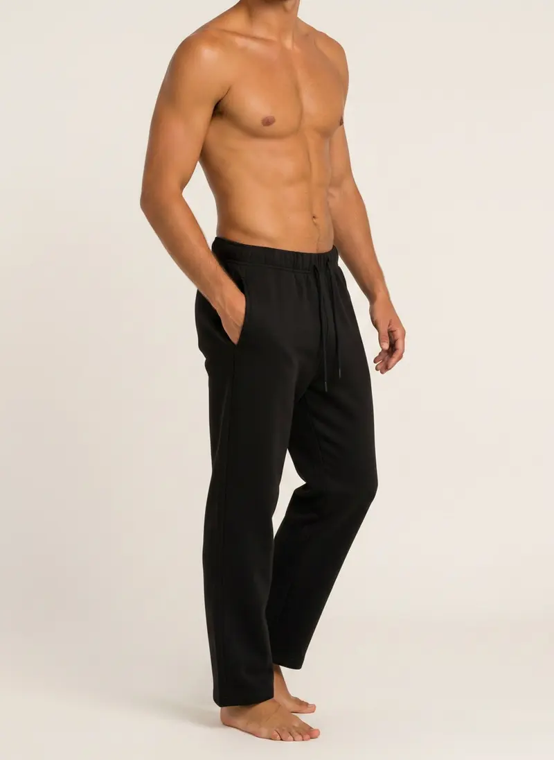 Future Homme black straight lounge pant shot bare-chest, three-quarter turn with hand in pocket, on an AI male model