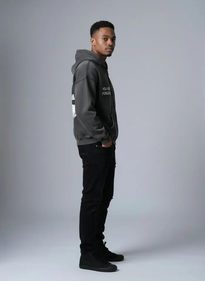 Godzeal YOU ARE FORGIVEN grey acid wash zip hoodie side profile pose on AI male model in clean American studio