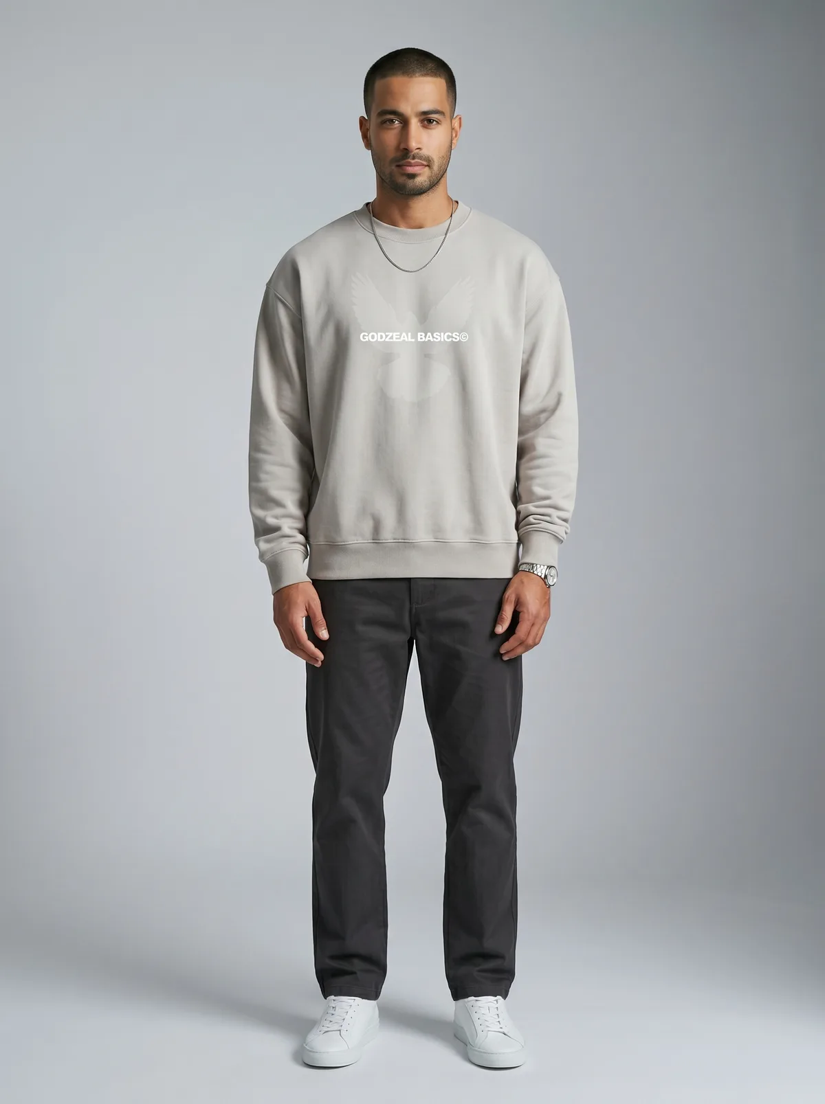 Godzeal Basics beige dove-logo crewneck sweater on AI male model with shaved fade in clean American studio with full-body framing
