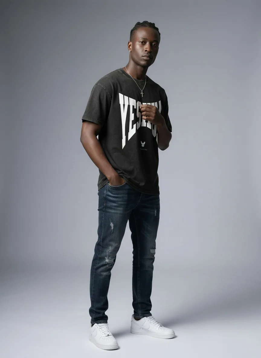 Godzeal YESHUA acid wash tee three-quarter pose on AI male model with cross necklace in clean studio