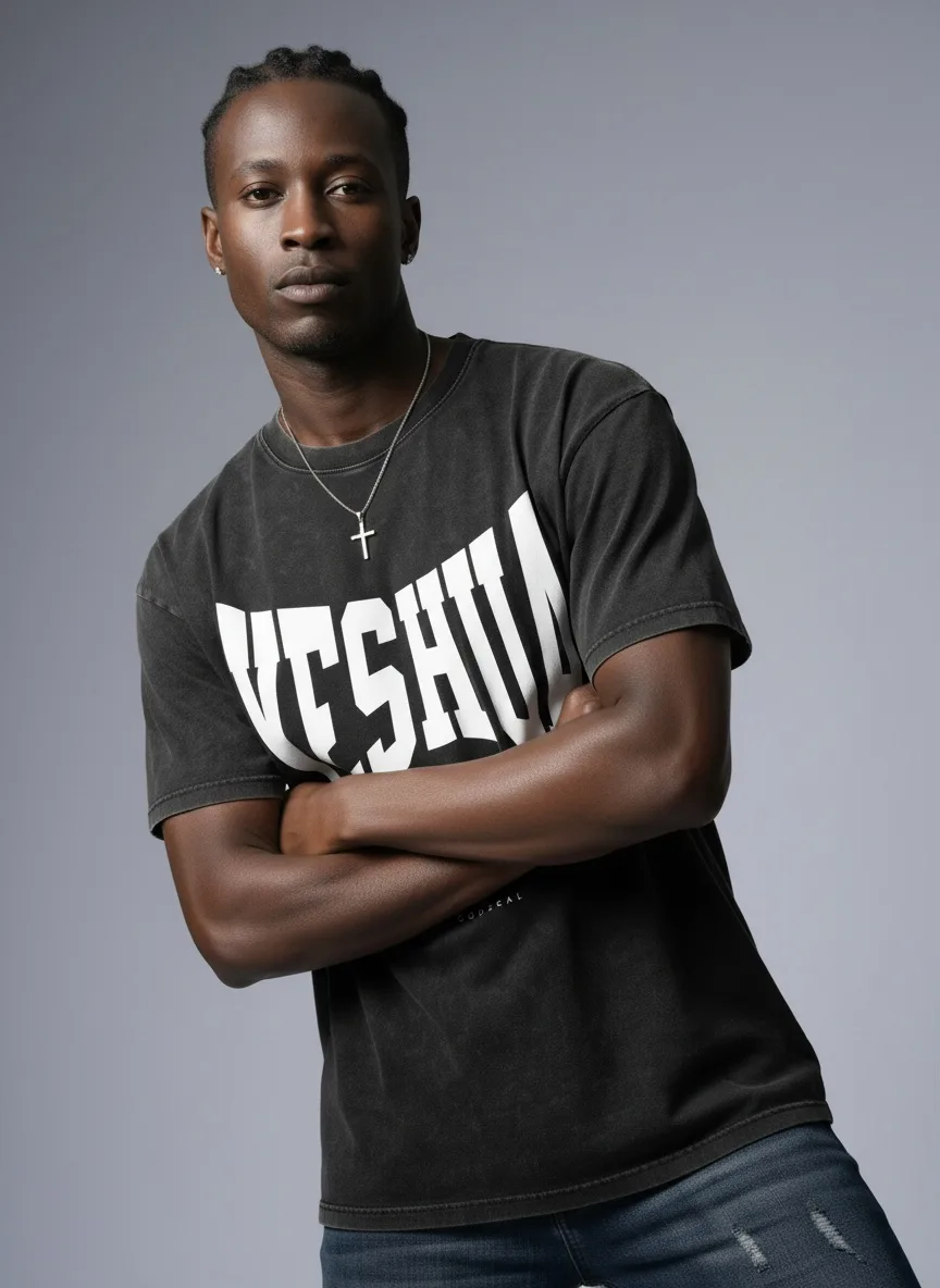 Godzeal YESHUA black acid wash tee arms-crossed editorial portrait on AI male model in studio