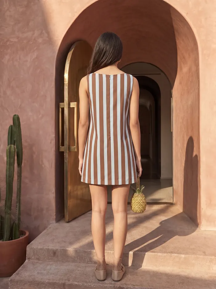 Maison Blu cocoa stripe palm-pocket mini dress back view on AI model in Marrakech terracotta arch