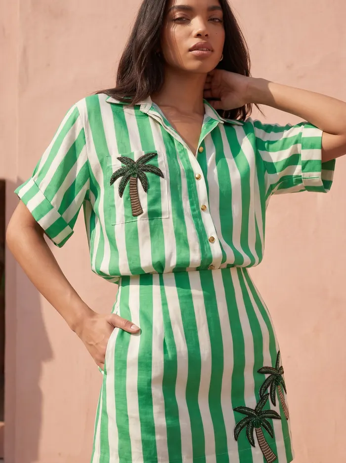 Maison Blu green stripe palm-print shirt and skirt set detail crop showing palm pocket motif on AI model