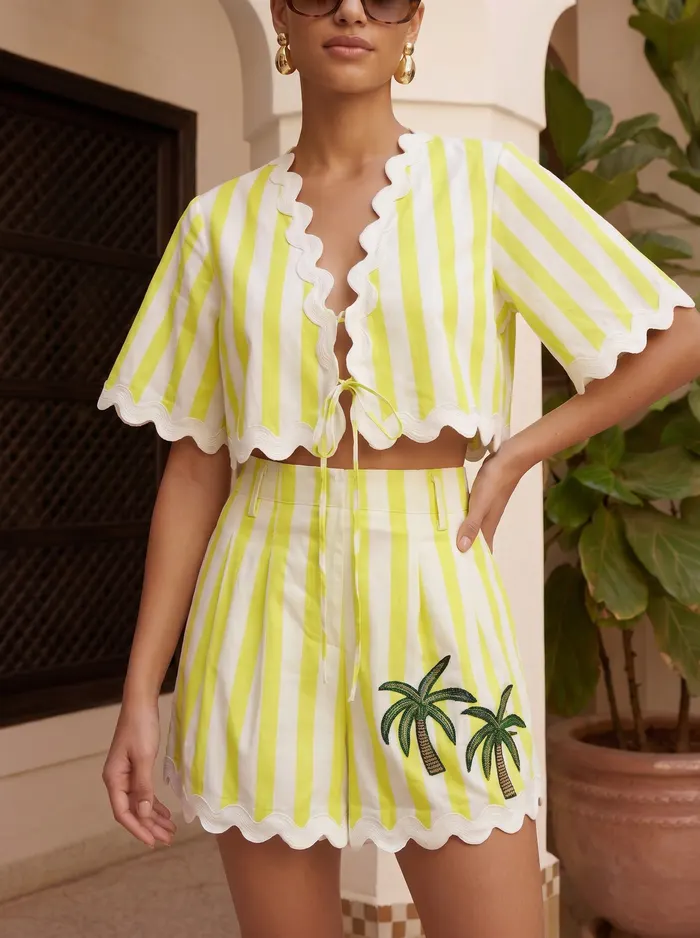 Maison Blu lime stripe scallop crop top and shorts capsule detail crop on AI model in Moroccan tiled courtyard