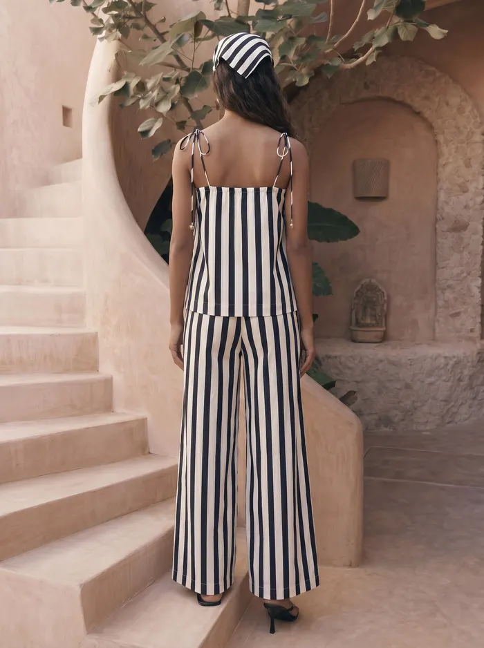 Maison Blu navy stripe starfish two-piece set back view on AI model with headscarf in Marrakech courtyard