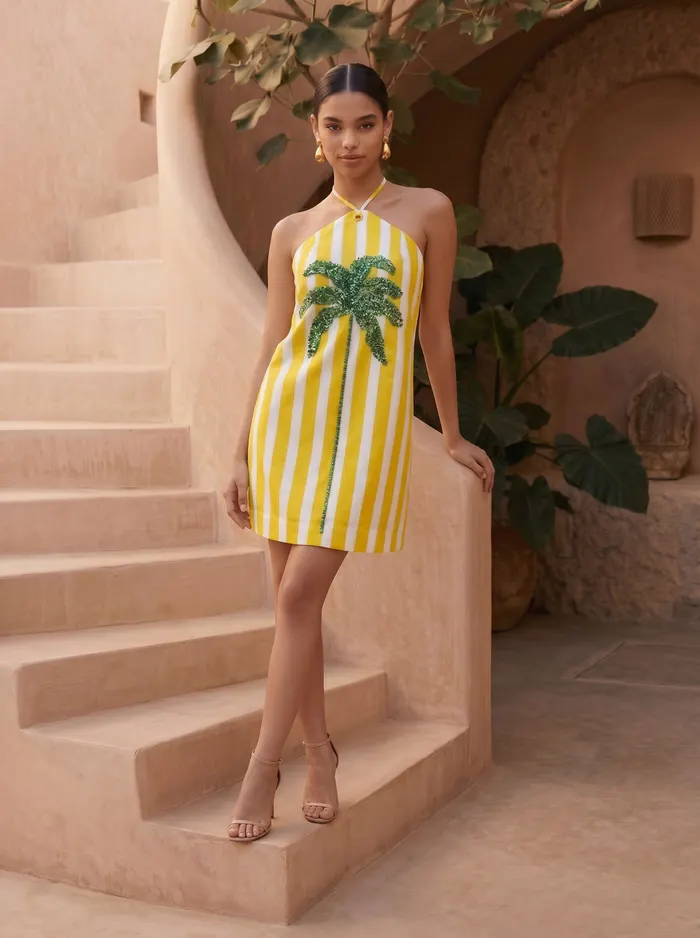 Maison Blu yellow halter sequin palm dress editorial styling pose on AI model in Marrakech stairwell