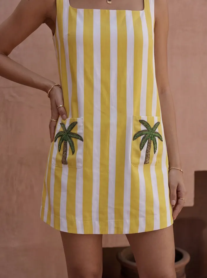 Maison Blu yellow stripe palm-pocket dress detail crop showing twin palm-tree sequin pocket embroidery
