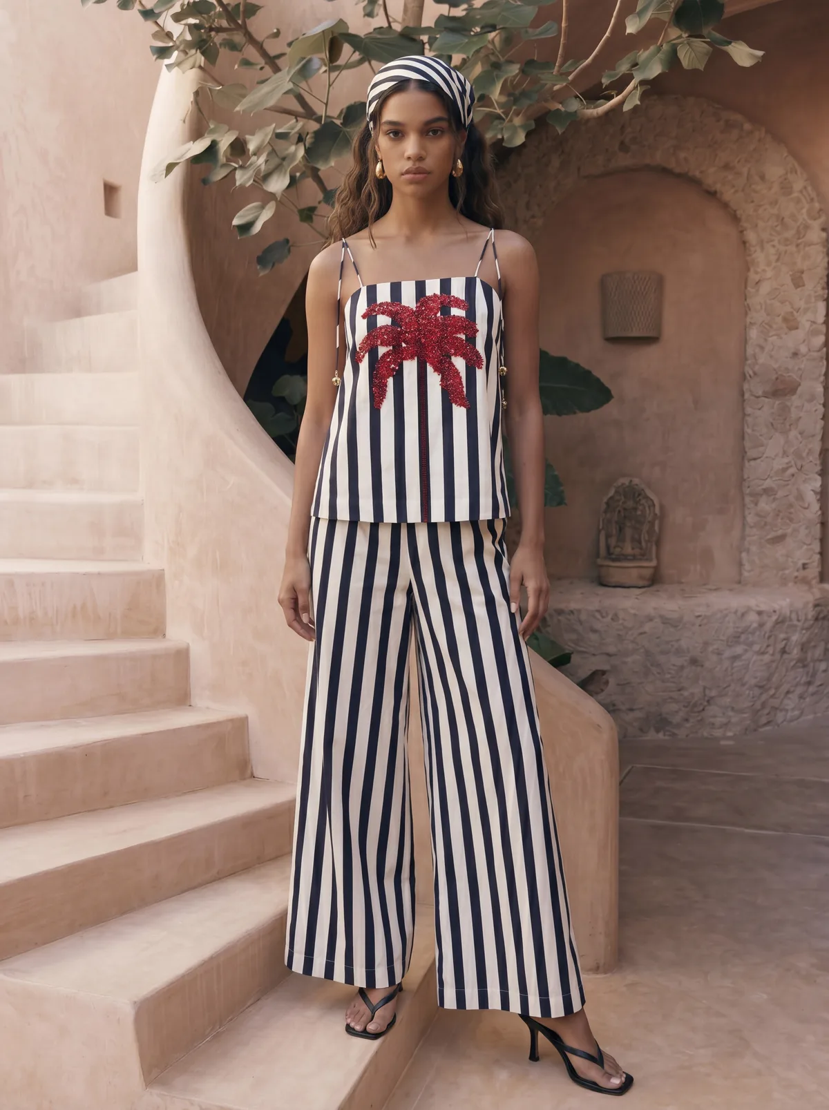 Maison Blu navy and white stripe starfish-print cami top and wide-leg pants set on AI model in Marrakech courtyard