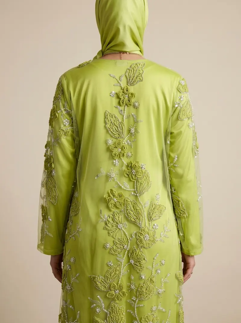 Modest Valoria lime abaya back view showing the hijab drape and the embroidery across the back panel