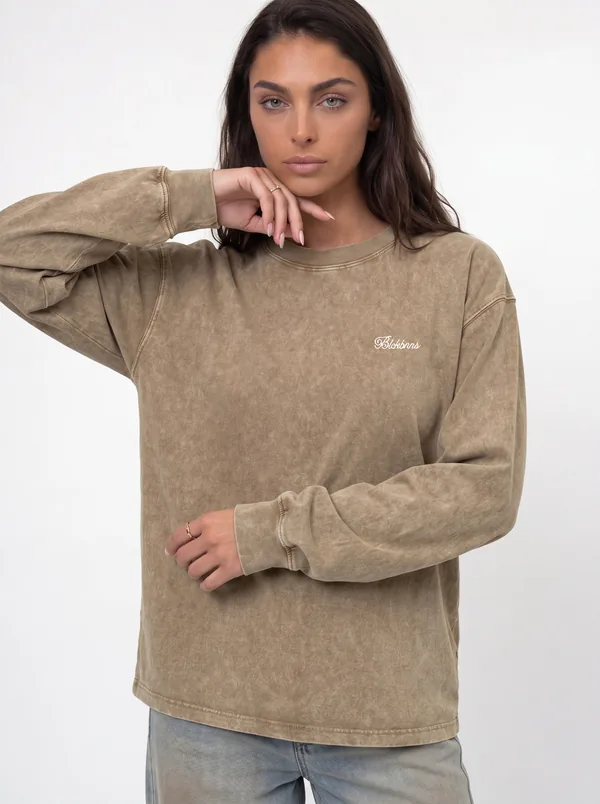 MODA AI unified catalog shot — tan acid-wash long-sleeve tee on model, matching storefront styling