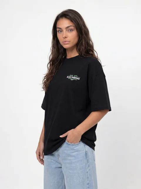 AI-generated three-quarter front angle — black oversized tee with hand in pocket