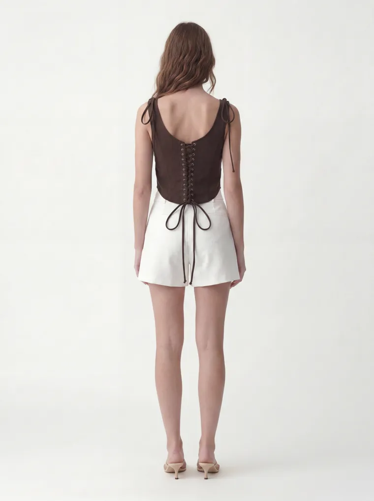 MODA AI catalog output — the vest top in chocolate brown, three-quarter angle on the shared model and studio