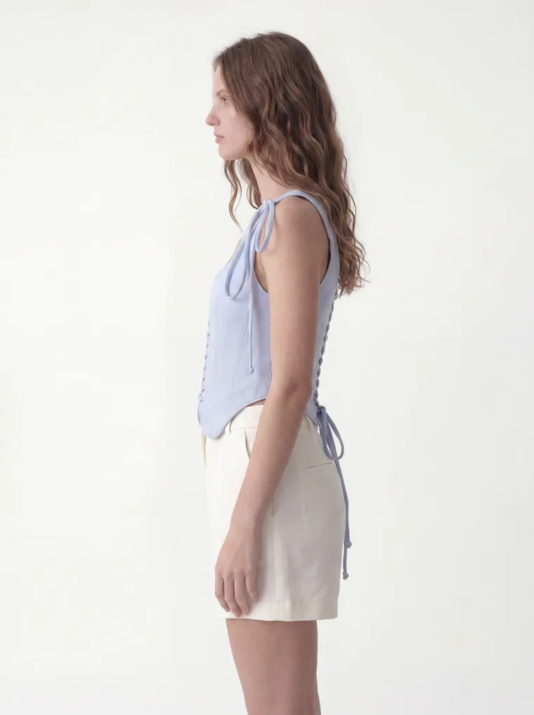 MODA AI catalog output — the vest top in powder blue, seated