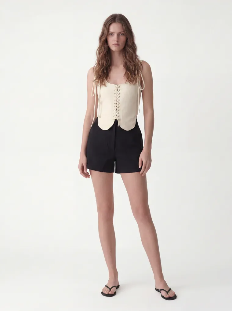 MODA AI catalog output — the lace-up scallop vest top in cream on a model, front, clean studio