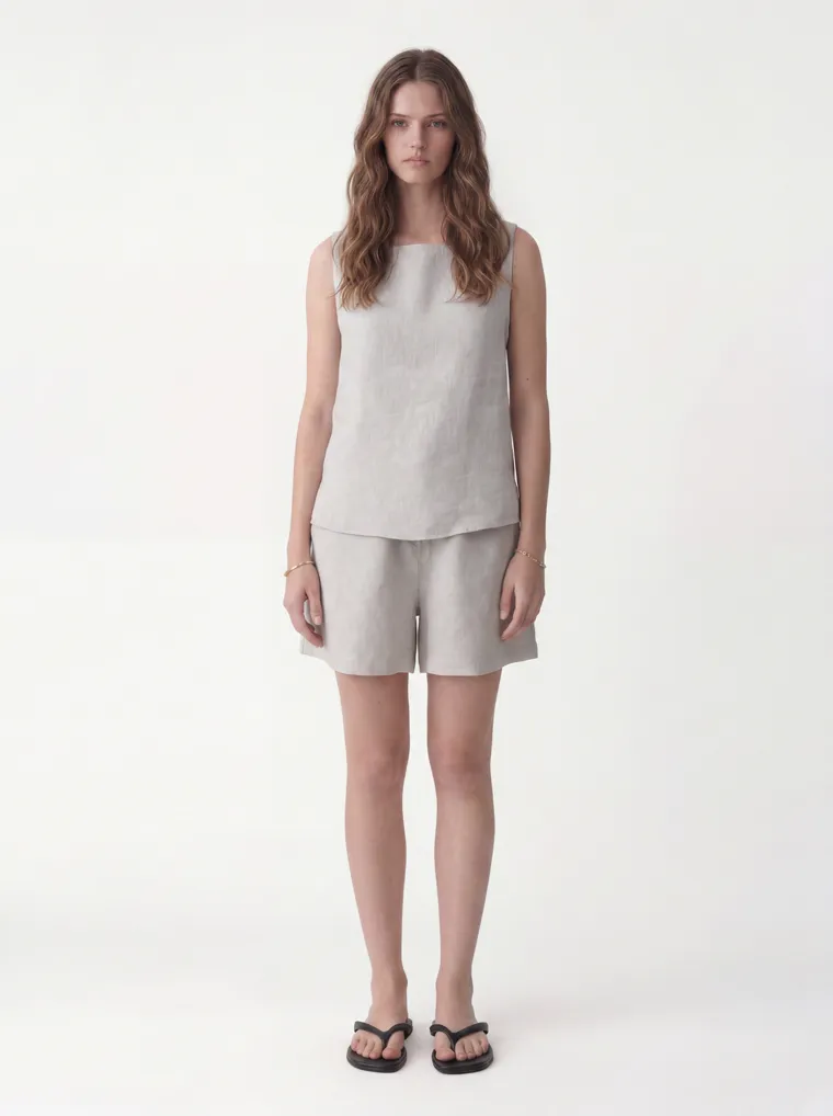 MODA AI catalog output — a linen tank-and-shorts set in oatmeal on the same model and studio as the vest